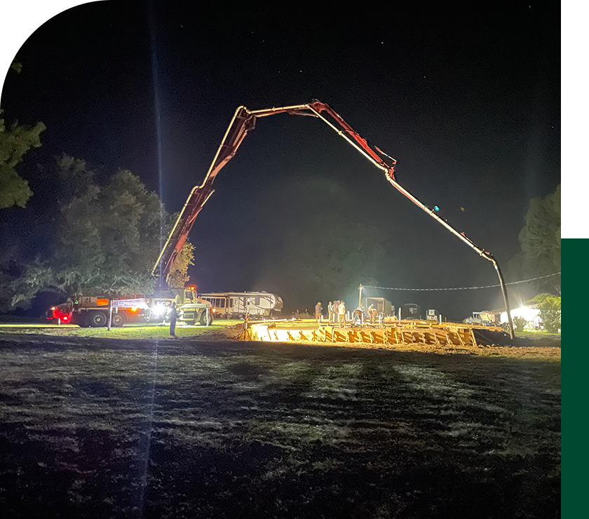 A large crane is in the middle of an open field.