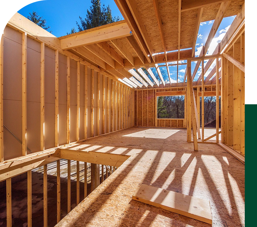 A room with wood framing and windows in it.