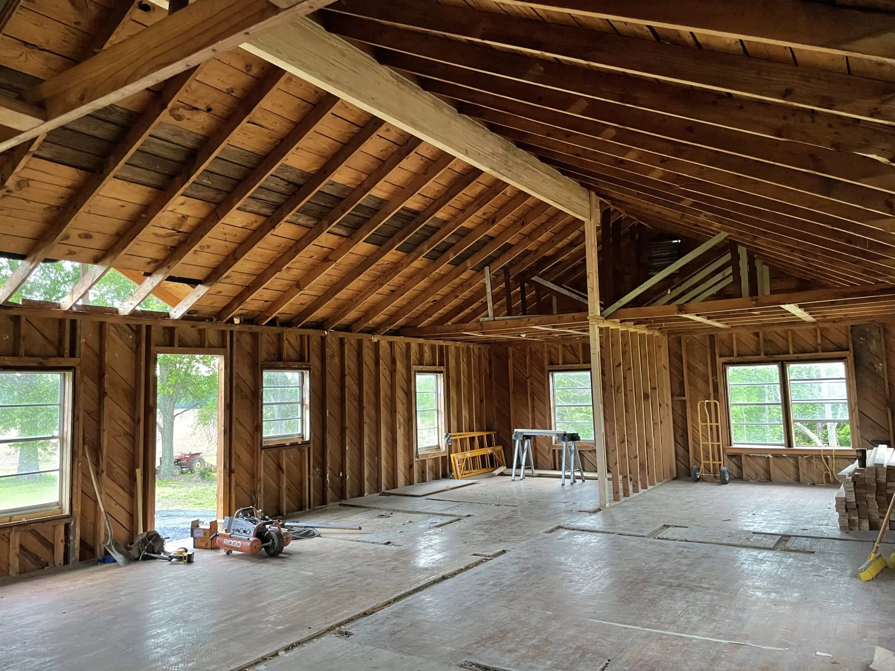 A room with wood walls and ceiling in it