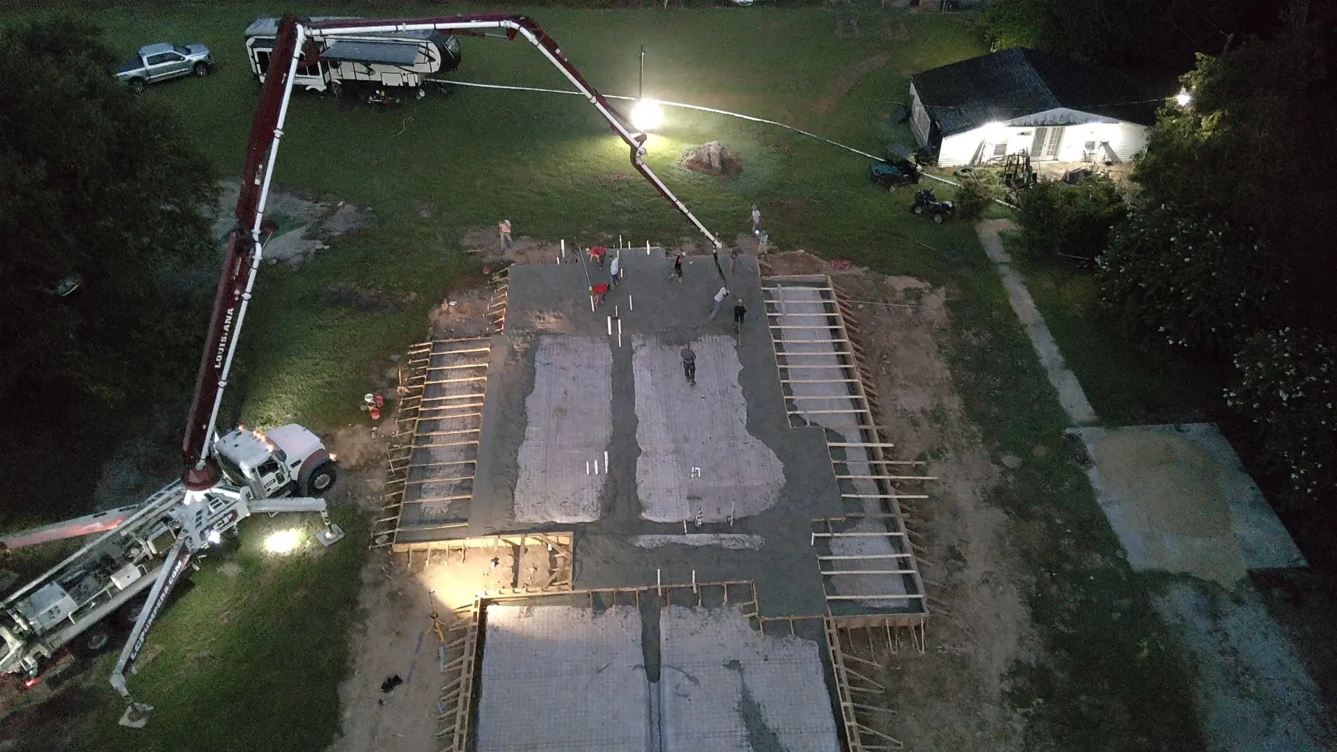 A group of people standing around in the dark.