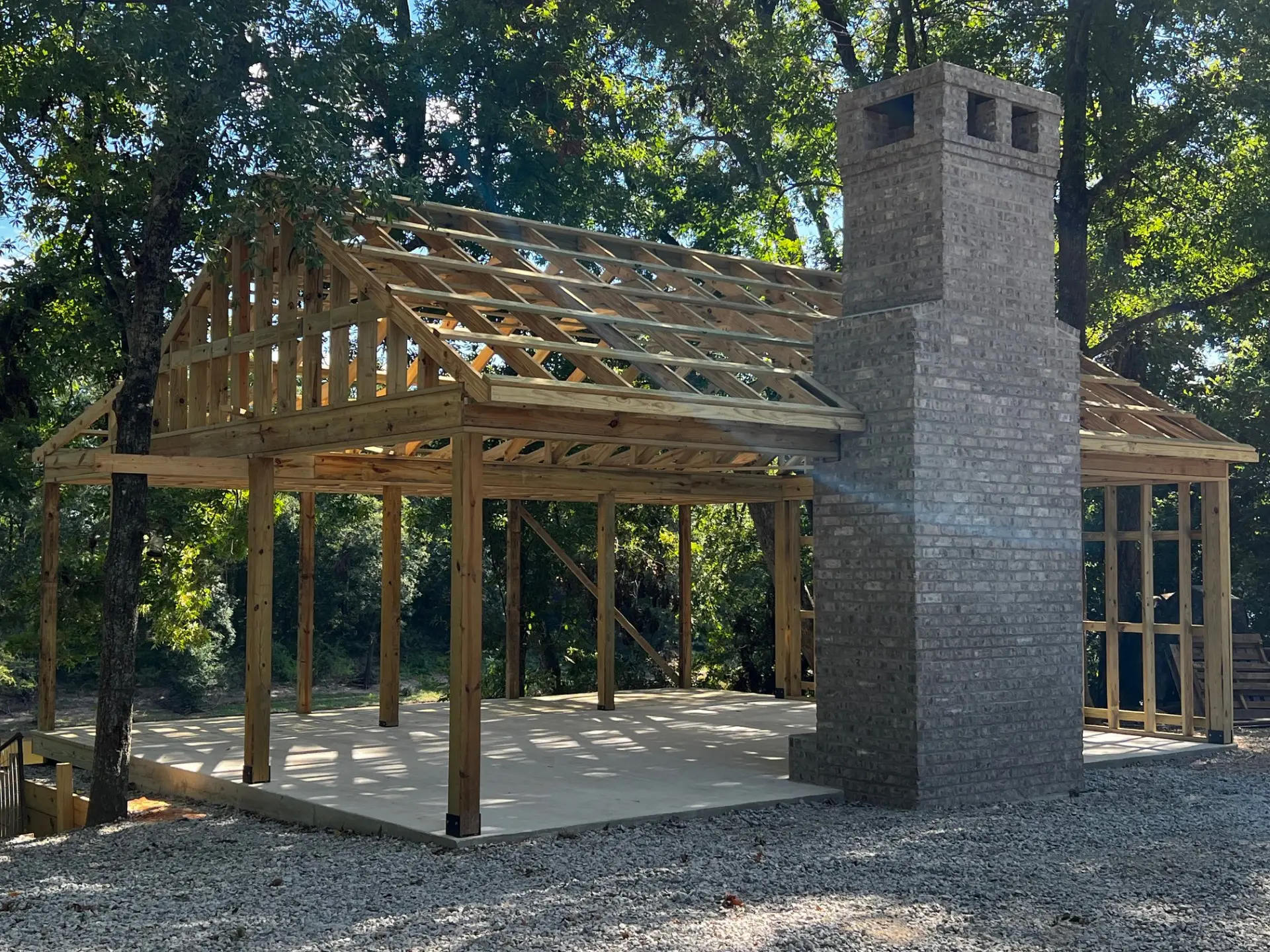 A building under construction with a brick chimney.