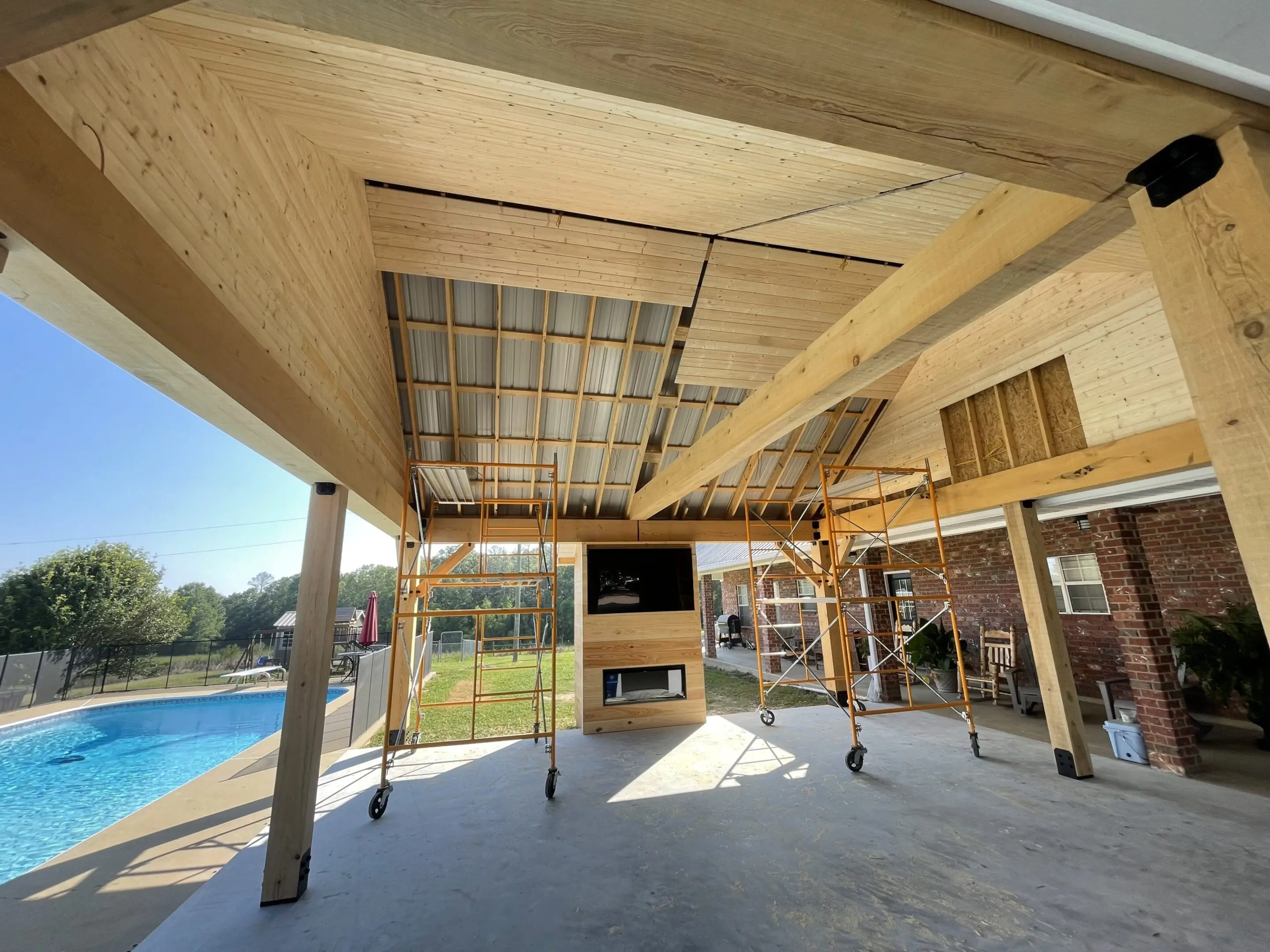 A large open area with a fireplace and pool.